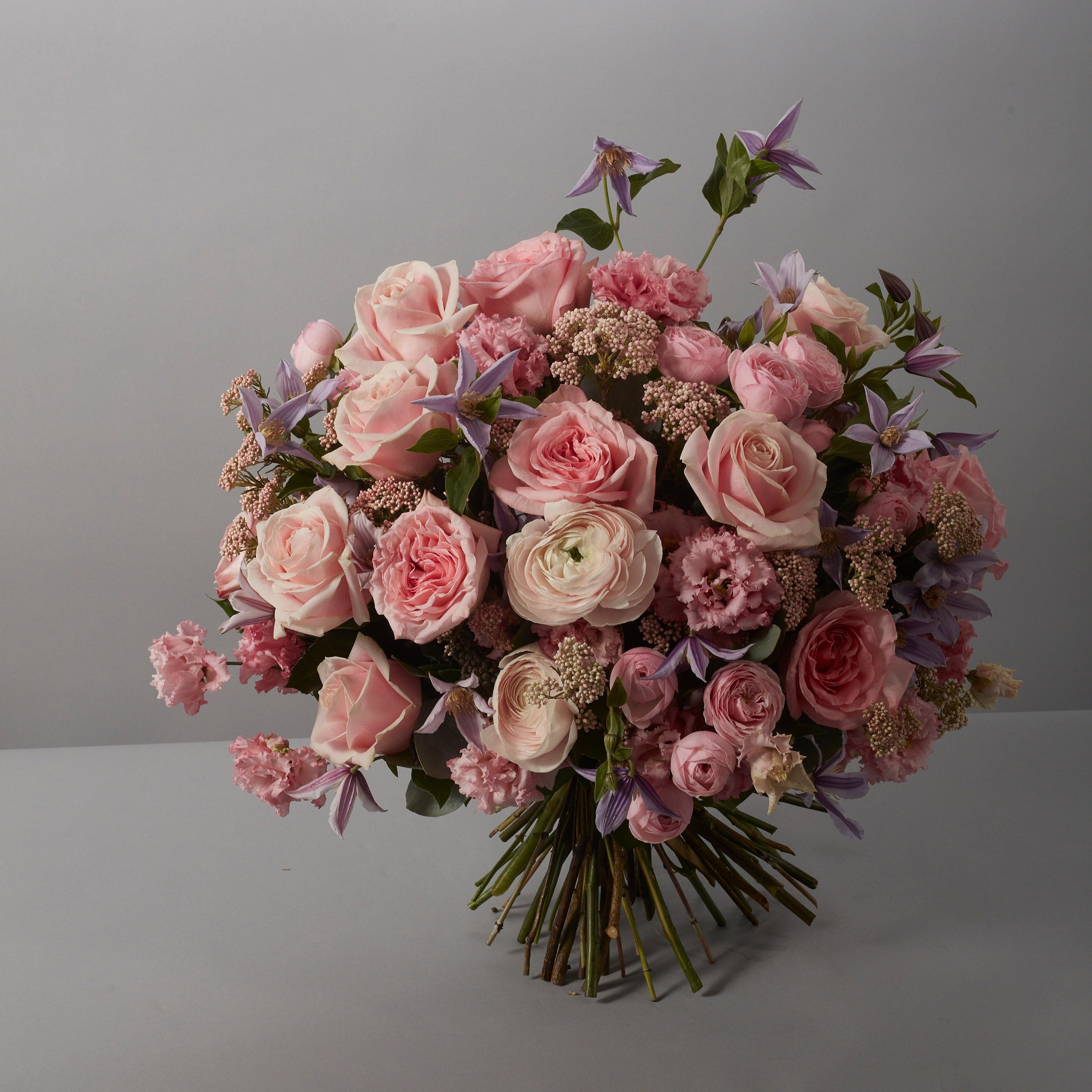 Bouquet of pink and white flowers on a plain background